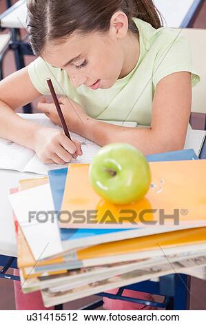 Stock Image - Little girl studying. Fotosearch