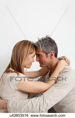 Lovely couple looking at each other View Large Photo Image Stock Photograph - Lovely couple looking at each other. Fotosearch