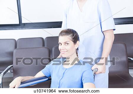 Male nurse helping a woman View Large Photo Image Picture - Male nurse helping a woman. Fotosearch