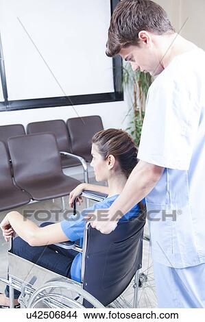 Male nurse helping a woman View Large Photo Image Picture - Male nurse helping a woman. Fotosearch