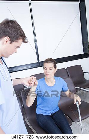 Male nurse helping a woman View Large Photo Image Stock Image - Male nurse helping a woman. Fotosearch
