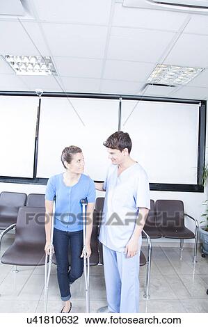 Male nurse helping a woman View Large Photo Image Stock Image - Male nurse helping a woman. Fotosearch