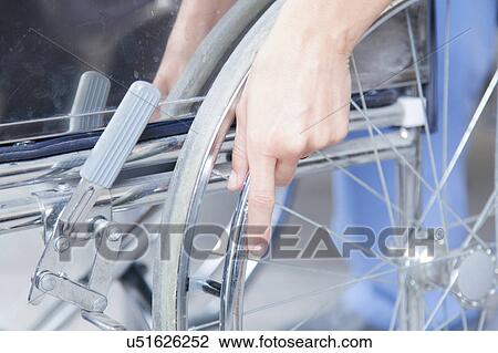 Stock Image - Male nurse helping a woman. Fotosearch