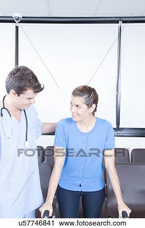 Male nurse helping a woman View Large Photo Image Stock Image - Male nurse helping a woman. Fotosearch