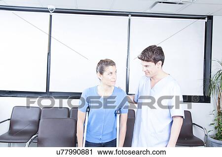 Male nurse helping a woman View Large Photo Image Stock Image - Male nurse helping a woman. Fotosearch