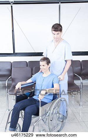 Male nurse helping a woman View Large Photo Image Stock Photo - Male nurse helping a woman. Fotosearch