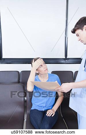 Stock Photo - Male nurse helping a woman. Fotosearch