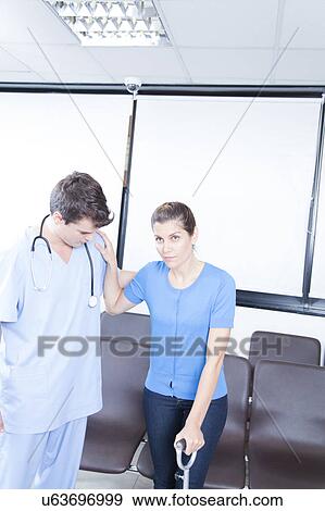 Male nurse helping a woman View Large Photo Image Stock Photo - Male nurse helping a woman. Fotosearch