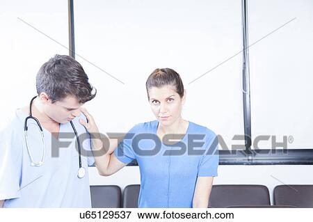 Stock Photo - Male nurse helping a woman. Fotosearch