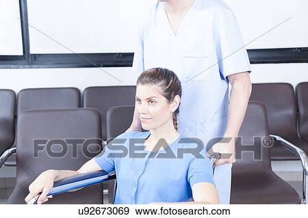 Male nurse helping a woman View Large Photo Image Stock Photo - Male nurse helping a woman. Fotosearch