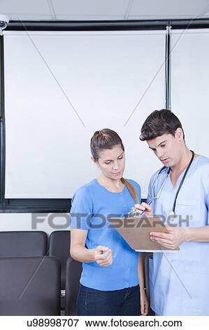 Male nurse helping a woman View Large Photo Image Stock Photo - Male nurse helping a woman. Fotosearch