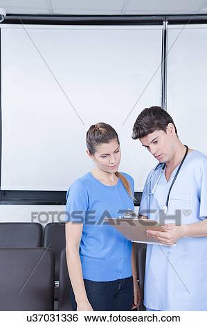 Male nurse helping a woman View Large Photo Image Stock Photograph - Male nurse helping a woman. Fotosearch