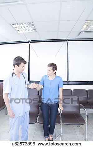 Male nurse helping a woman View Large Photo Image Stock Photograph - Male nurse helping a woman. Fotosearch