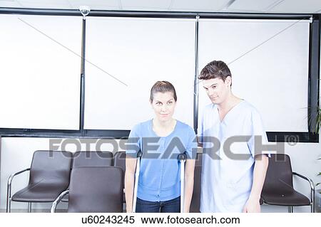 Stock Photography - Male nurse helping a woman. Fotosearch