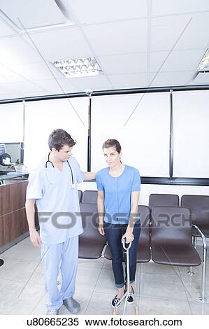 Male nurse helping a woman View Large Photo Image Stock Photography - Male nurse helping a woman. Fotosearch