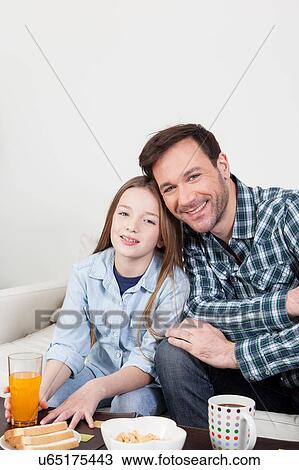 Man and his daughter having the breakfast View Large Photo Image Stock Image - Man and his daughter having the breakfast. Fotosearch