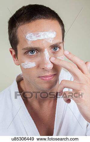 Man applying cream on face View Large Photo Image Stock Photo - Man applying cream on face. Fotosearch