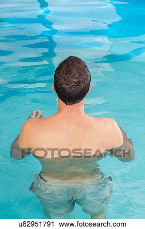 Man back inside the pool View Large Photo Image Stock Image - Man back inside the pool. Fotosearch