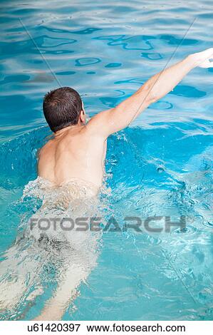 Man back swimming View Large Photo Image Stock Photo - Man back swimming . Fotosearch