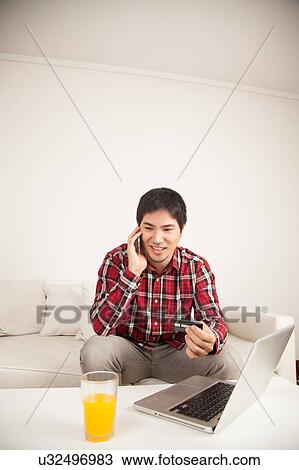 Man buying by network and talking by phone View Large Photo Image Stock Image - Man buying by network and talking by phone. Fotosearch