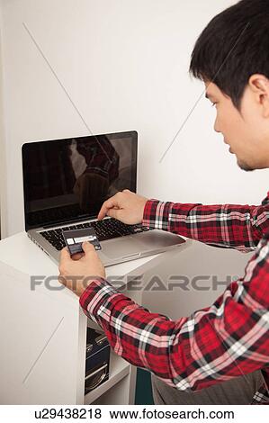 Stock Photo - Man buying by network. Fotosearch