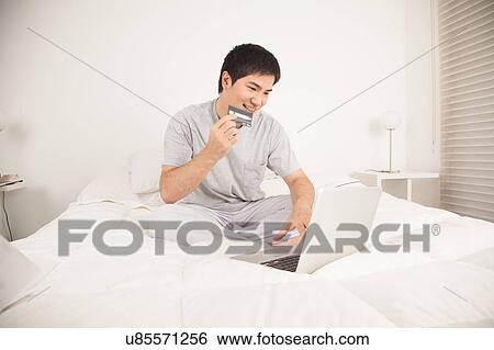 Stock Photograph - Man buying by network. Fotosearch