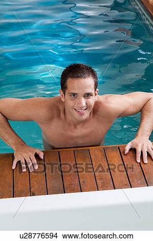 Picture - Man coming out of the pool. Fotosearch