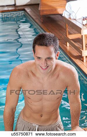 Stock Image - Man coming out of the pool. Fotosearch