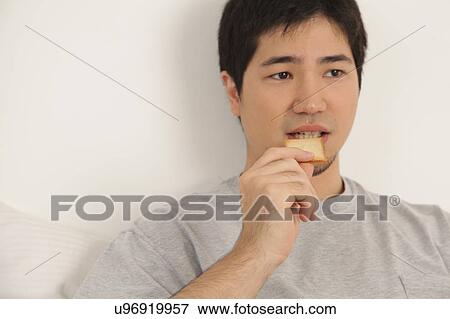Man eating a toast View Large Photo Image Stock Photo - Man eating a toast. Fotosearch