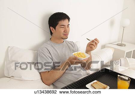 Man eating cereals View Large Photo Image Stock Image - Man eating cereals. Fotosearch