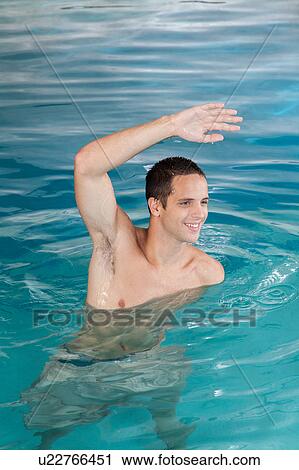 Man exercising in the pool View Large Photo Image Stock Image - Man exercising in the pool. Fotosearch