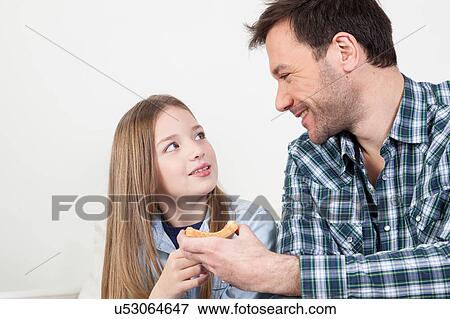 Stock Photo - Man gives a toast to his daughter. Fotosearch