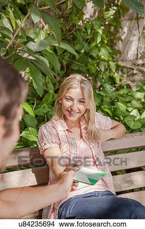 Man giving a card to his girlfriend View Large Photo Image Picture - Man giving a card to his girlfriend. Fotosearch