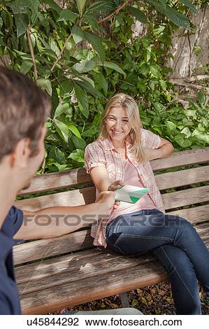 Man giving a card to his girlfriend View Large Photo Image Stock Image - Man giving a card to his girlfriend. Fotosearch