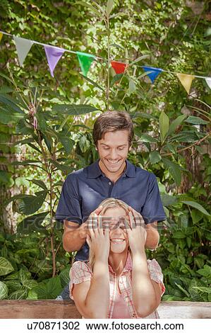 Man giving a surprise to his girlfriend View Large Photo Image Stock Image - Man giving a surprise to his girlfriend. Fotosearch