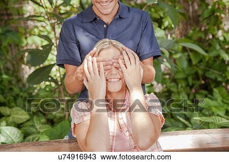 Man giving a surprise to his girlfriend View Large Photo Image Stock Image - Man giving a surprise to his girlfriend. Fotosearch
