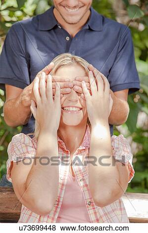 Man giving a surprise to his girlfriend View Large Photo Image Stock Photo - Man giving a surprise to his girlfriend. Fotosearch