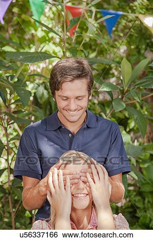 Man giving a surprise to his girlfriend View Large Photo Image Stock Photograph - Man giving a surprise to his girlfriend. Fotosearch