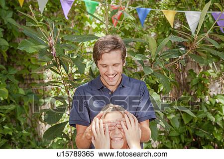 Man giving a surprise to his girlfriend View Large Photo Image Stock Photography - Man giving a surprise to his girlfriend. Fotosearch
