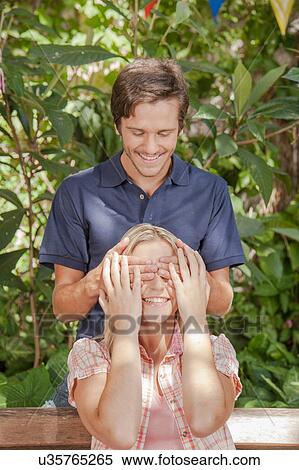 Man giving a surprise to his girlfriend View Large Photo Image Stock Photography - Man giving a surprise to his girlfriend. Fotosearch