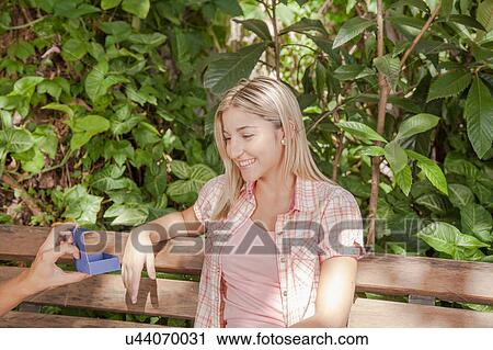 Man giving to his girlfriend a surprice View Large Photo Image Stock Image - Man giving to his girlfriend a surprice. Fotosearch