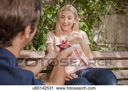 Man giving to his girlfriend a surprice View Large Photo Image Stock Image - Man giving to his girlfriend a surprice. Fotosearch