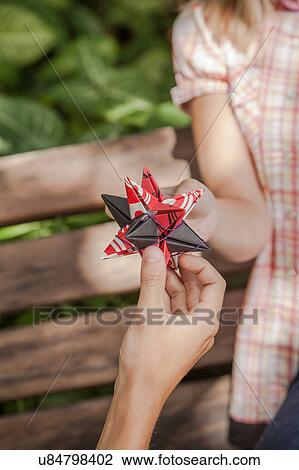 Stock Image - Man giving to his girlfriend a surprice. Fotosearch