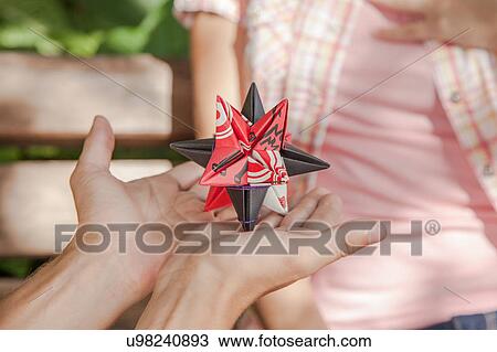 Stock Image - Man giving to his girlfriend a surprice. Fotosearch