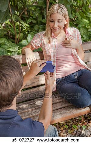 Man giving to his girlfriend a surprice View Large Photo Image Stock Photo - Man giving to his girlfriend a surprice. Fotosearch