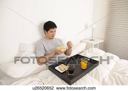 Stock Image - Man having a breakfast. Fotosearch