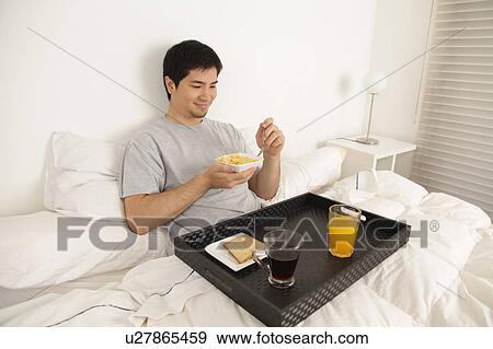 Stock Photo - Man having a breakfast. Fotosearch