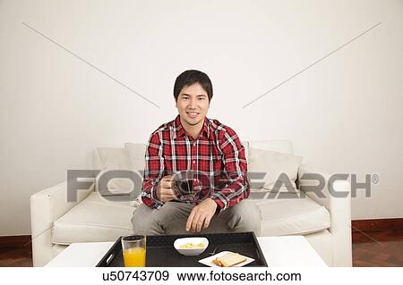 Stock Photo - Man having a breakfast. Fotosearch