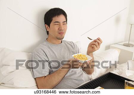 Stock Photograph - Man having a breakfast. Fotosearch