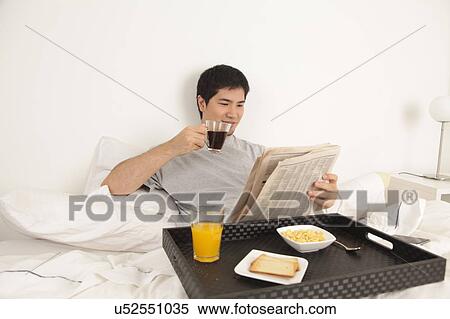 Man having a breakfast while reading the newspaper View Large Photo Image Stock Photography - Man having a breakfast while reading the newspaper. Fotosearch